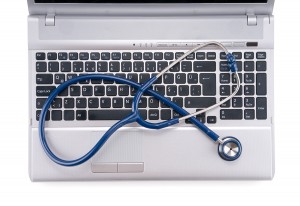 bigstock-Stethoscope-resting-on-a-compu-31701782